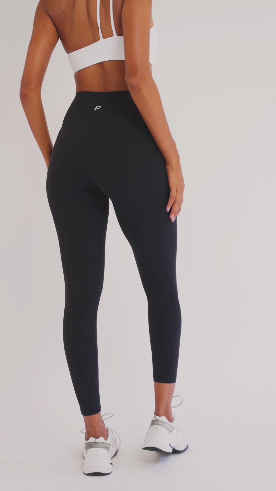 Load video: PilaNova Stirrup Leggings – Sleek Fit &amp; Bold Straps – Black