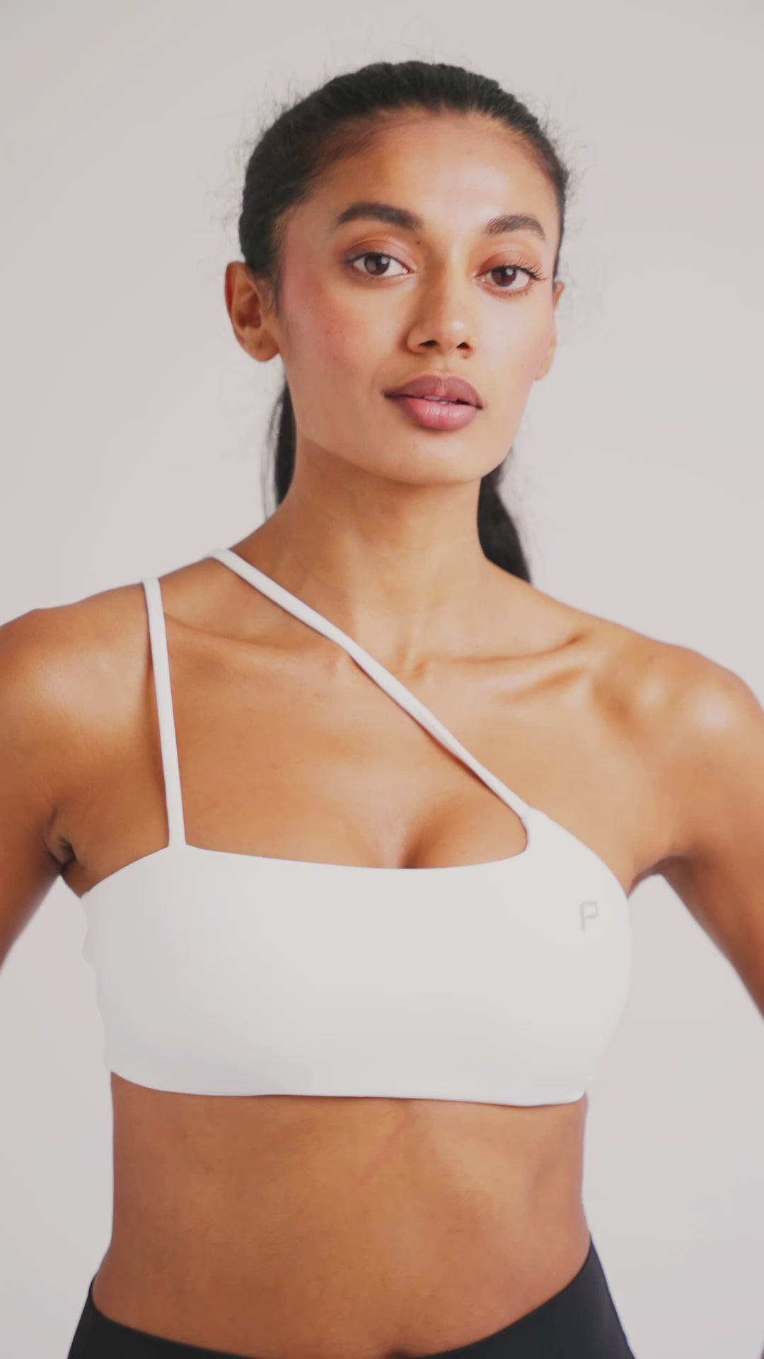 Load video: PilaNova Asymmetrical Sports Bra – Stylish Design &amp; Support – White